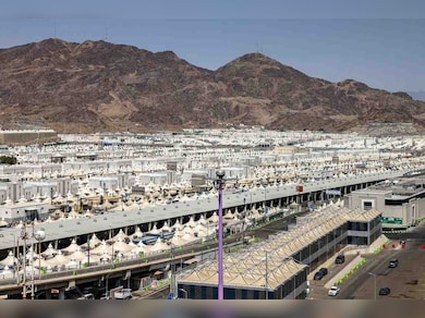 The site of a tragic accident near Medina where 42 Indian Umrah pilgrims lost their lives, showing Saudi Civil Defense teams securing the area.