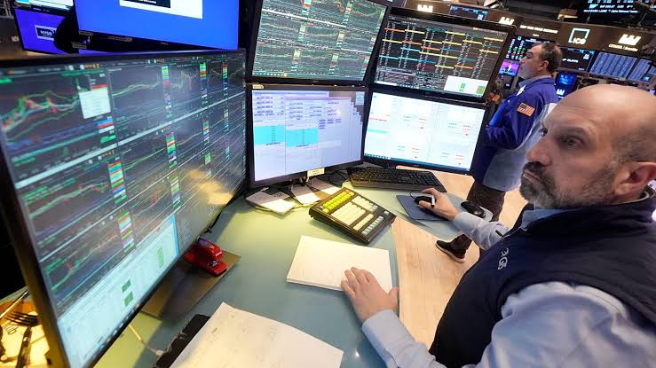 Specialist James Denaro works on the floor of the New York Stock Exchange.