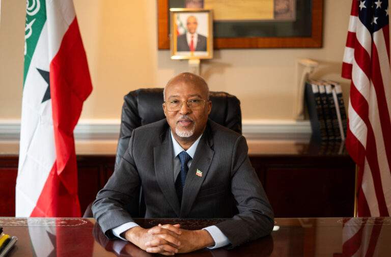 Somaliland representative Bashir Goth in his office with Somaliland and US flags